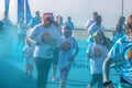 Ã¢â¬Å½April Ã¢â¬Å½6 Ã¢â¬Å½2019 Tulsa USA Mother and children run laughing through blue powder at color station at Color - holi run - looks